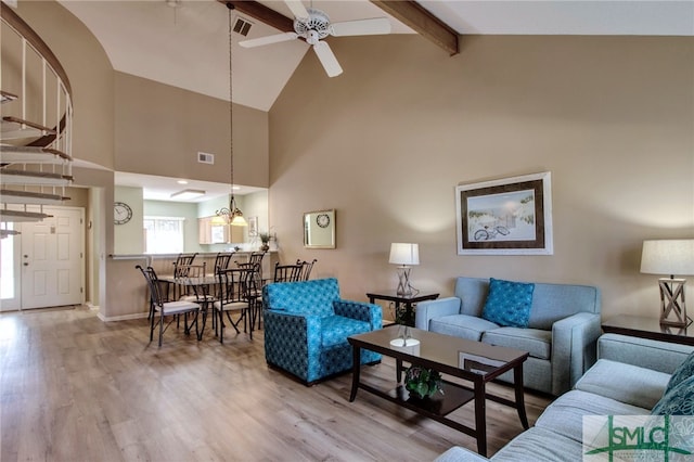 living room with beamed ceiling, hardwood / wood-style flooring, high vaulted ceiling, and ceiling fan