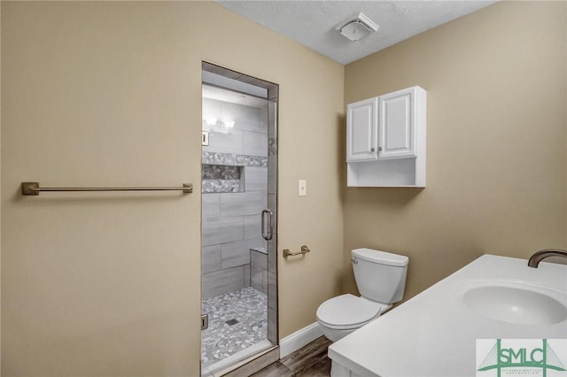 bathroom featuring walk in shower, vanity, and toilet