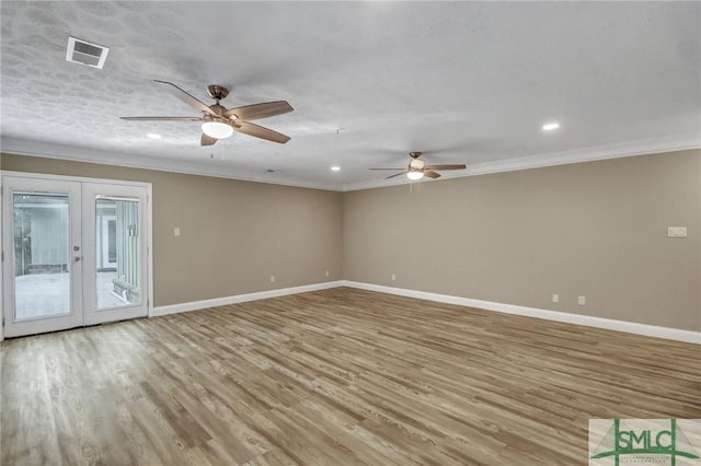 spare room featuring ornamental molding, ceiling fan, light wood-type flooring, and french doors