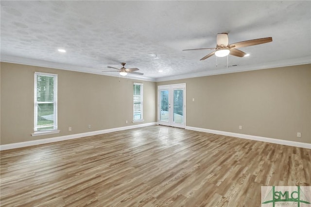 unfurnished room featuring light hardwood / wood-style flooring, ornamental molding, ceiling fan, a textured ceiling, and french doors