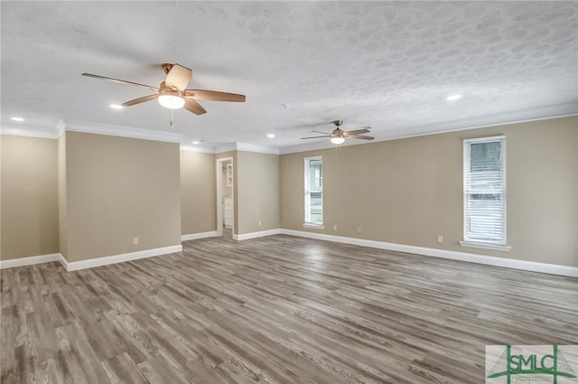 spare room featuring crown molding, ceiling fan, hardwood / wood-style flooring, and a textured ceiling