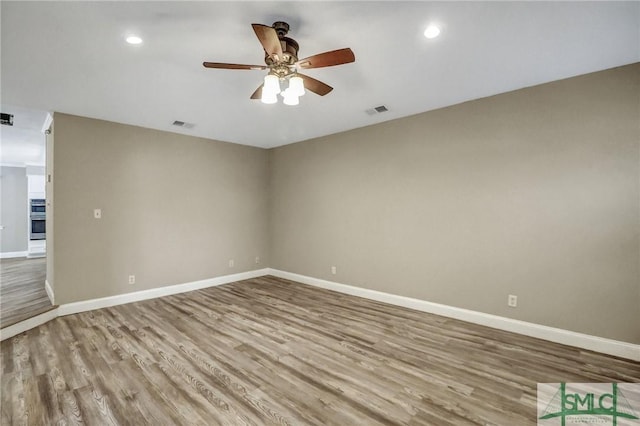 empty room featuring ceiling fan and light hardwood / wood-style floors