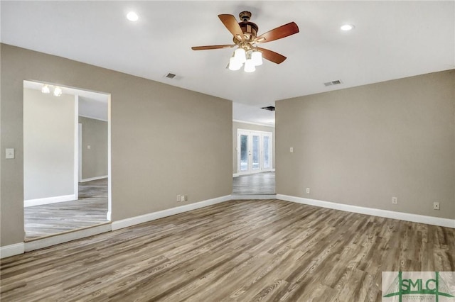 unfurnished room with ceiling fan and light hardwood / wood-style floors