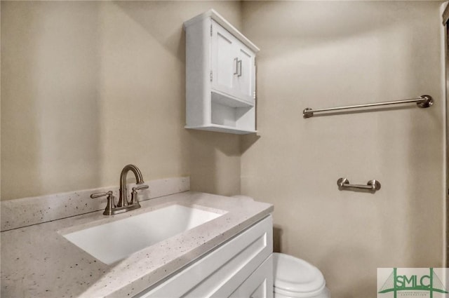 bathroom with vanity and toilet