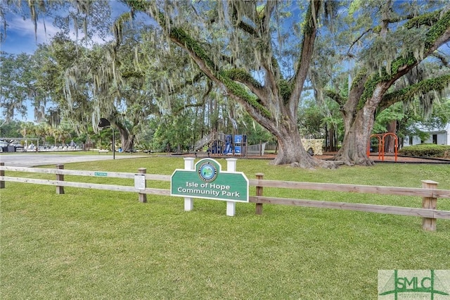 view of property's community featuring a playground and a lawn