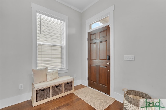 foyer with hardwood / wood-style floors and crown molding