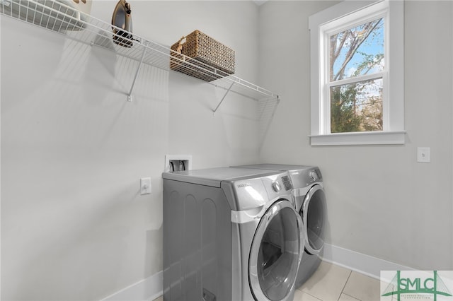 laundry room with light tile patterned flooring and independent washer and dryer