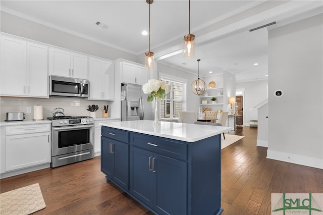 kitchen featuring dark hardwood / wood-style flooring, stainless steel appliances, blue cabinetry, decorative light fixtures, and white cabinets