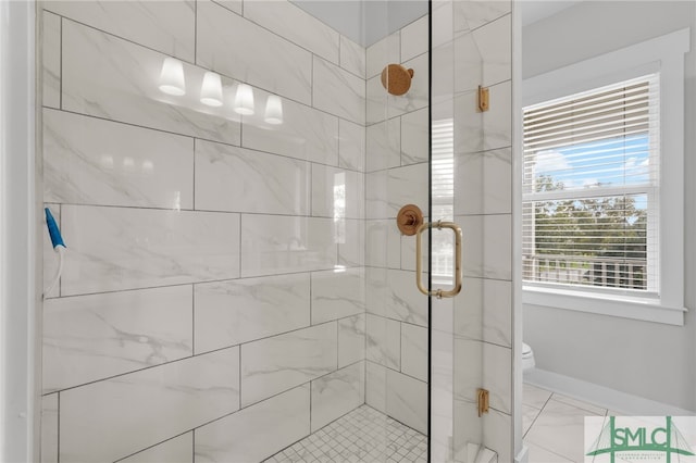 bathroom featuring toilet and an enclosed shower