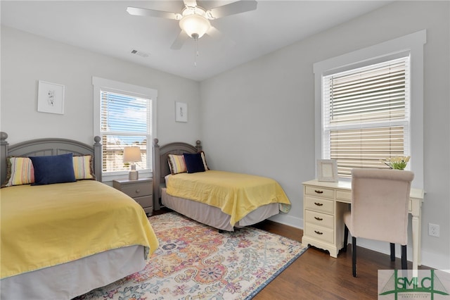 bedroom with ceiling fan and dark hardwood / wood-style flooring