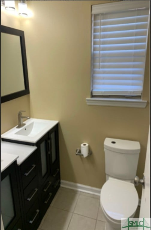 bathroom featuring tile patterned flooring, vanity, and toilet