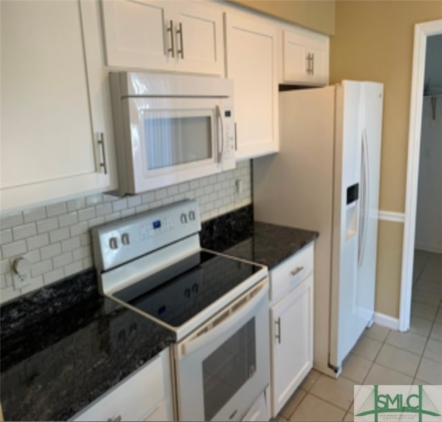 kitchen featuring backsplash, white cabinets, light tile patterned flooring, and white appliances