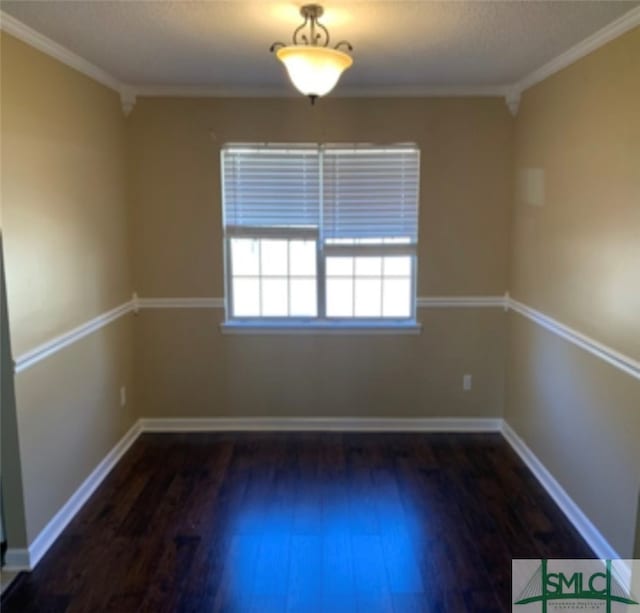 empty room featuring dark hardwood / wood-style floors and ornamental molding