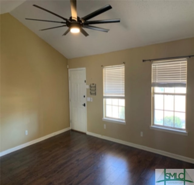 interior space featuring ceiling fan, dark wood-type flooring, and vaulted ceiling