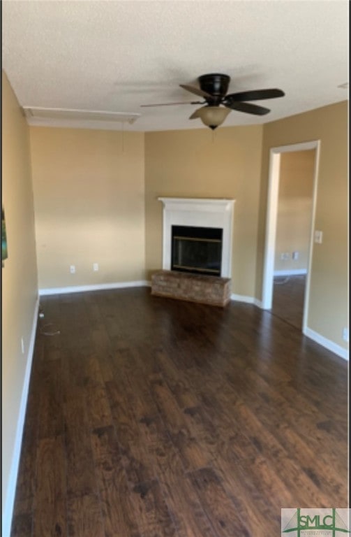 unfurnished living room featuring dark hardwood / wood-style floors and ceiling fan