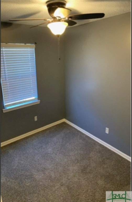 empty room featuring ceiling fan and carpet floors