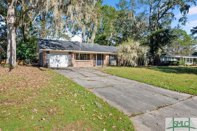 ranch-style house featuring a front lawn and a garage