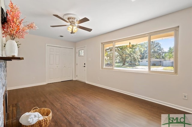 interior space with dark hardwood / wood-style flooring and ceiling fan