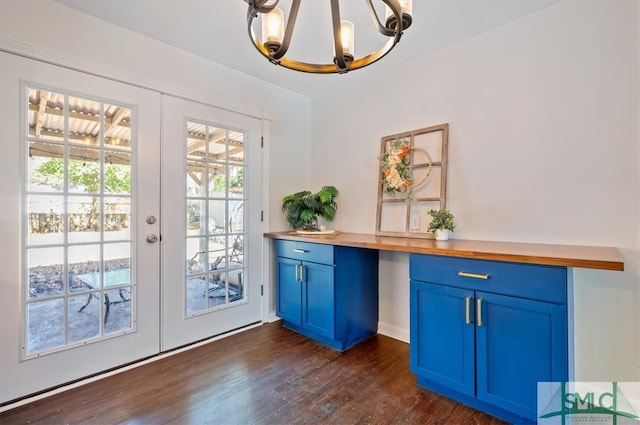 doorway to outside with french doors, dark hardwood / wood-style flooring, and a notable chandelier