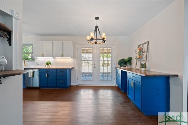 kitchen with stainless steel dishwasher, plenty of natural light, pendant lighting, and white cabinetry