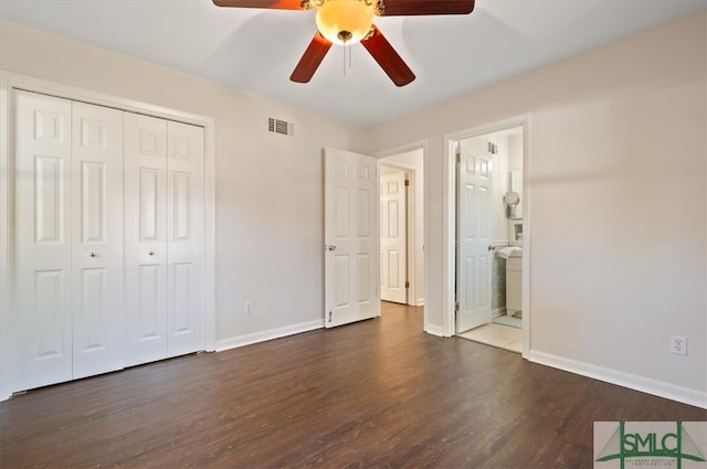 unfurnished bedroom with ceiling fan, a closet, ensuite bathroom, and dark hardwood / wood-style floors