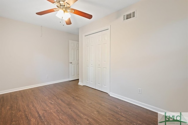 unfurnished bedroom featuring a closet, ceiling fan, and dark hardwood / wood-style flooring