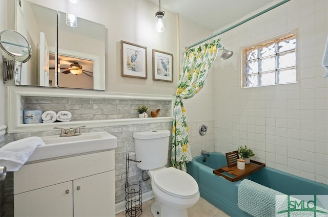 full bathroom with shower / bath combo, vanity, toilet, and tile walls