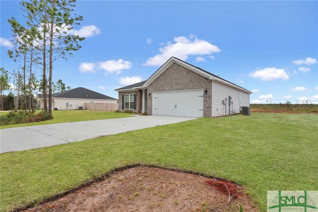 view of front of property with central AC, a front lawn, and a garage