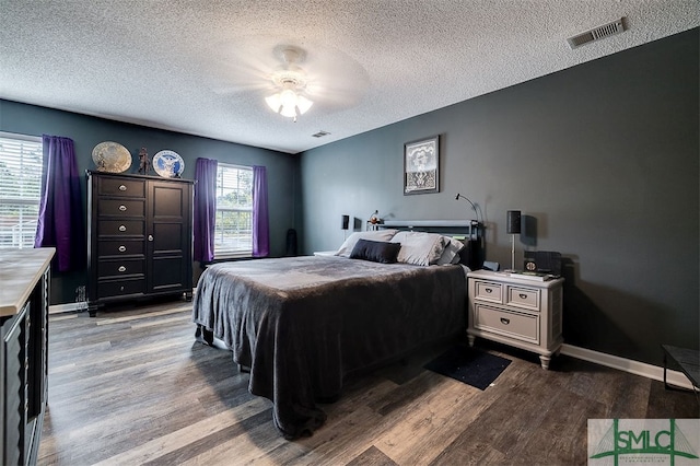 bedroom featuring ceiling fan, a textured ceiling, and light wood-type flooring