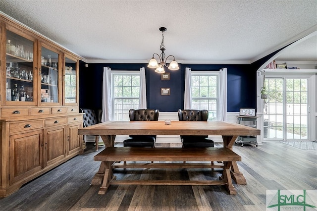 dining room featuring plenty of natural light, dark hardwood / wood-style flooring, and ornamental molding