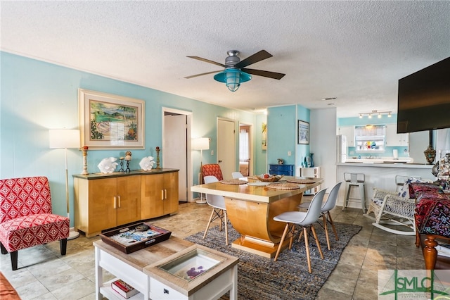 interior space featuring ceiling fan and a textured ceiling