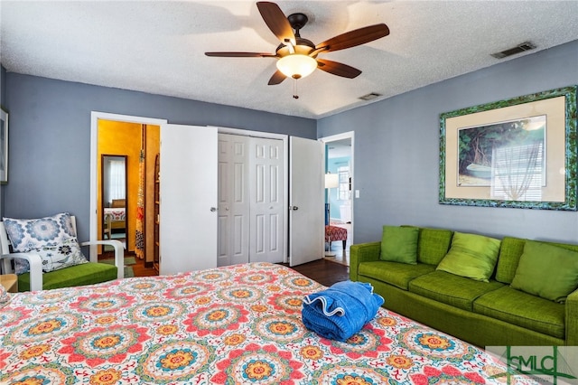 bedroom featuring multiple windows, ceiling fan, a closet, and a textured ceiling