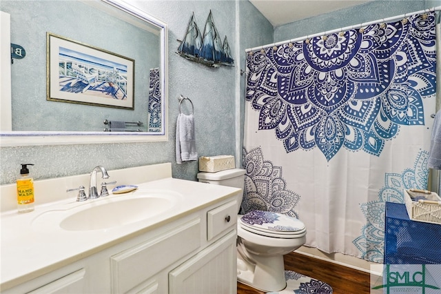 bathroom with a shower with shower curtain, vanity, wood-type flooring, and toilet