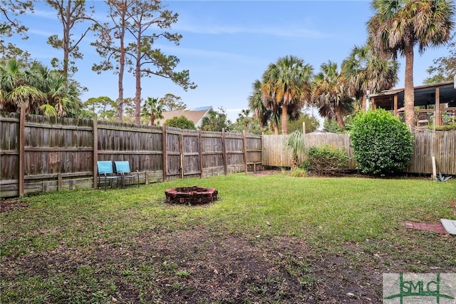 view of yard with a fire pit