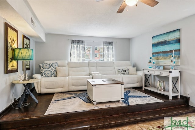 living room featuring hardwood / wood-style floors and ceiling fan