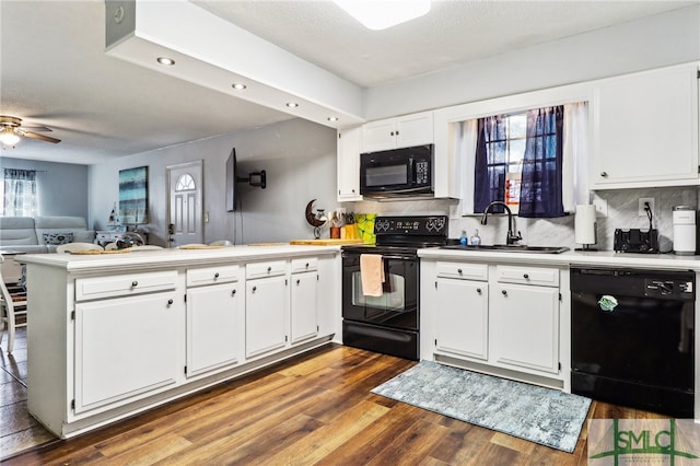 kitchen with white cabinetry, sink, tasteful backsplash, dark hardwood / wood-style floors, and black appliances