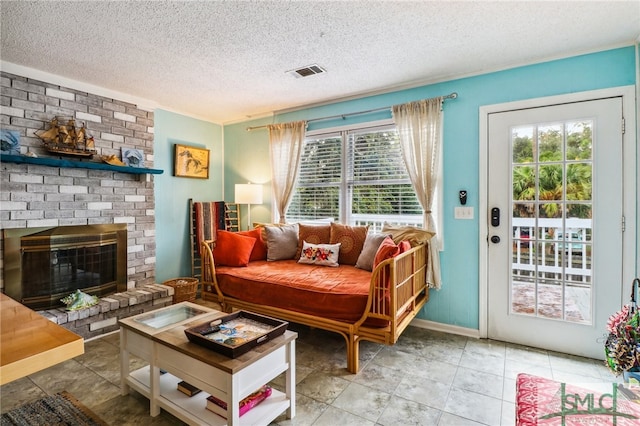 tiled living room with a textured ceiling and a fireplace