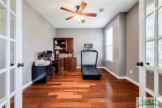 exercise room featuring french doors, dark hardwood / wood-style floors, a wealth of natural light, and ceiling fan