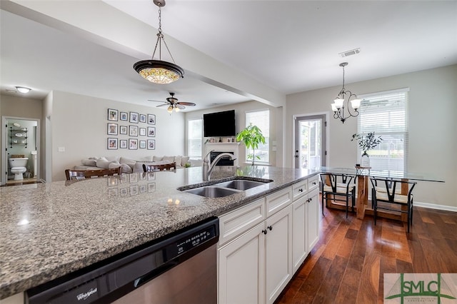 kitchen with white cabinets, sink, stainless steel dishwasher, dark hardwood / wood-style floors, and light stone countertops