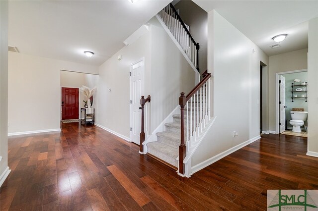 stairs featuring hardwood / wood-style flooring