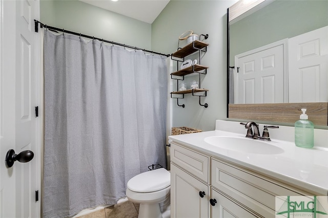 bathroom featuring toilet, vanity, and tile patterned floors