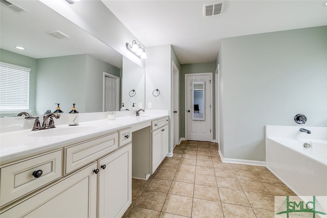 bathroom with vanity, tile patterned floors, and a bathing tub