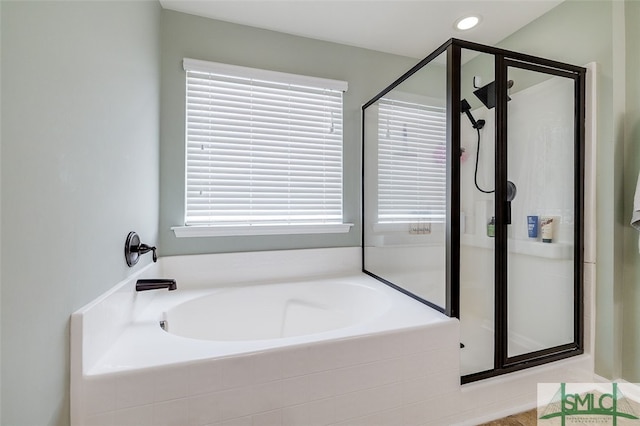 bathroom with separate shower and tub