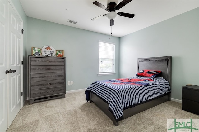 carpeted bedroom with ceiling fan and a closet