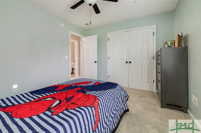 bedroom with ceiling fan, light colored carpet, and a closet