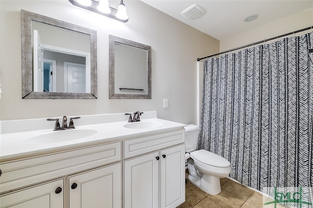 bathroom with tile patterned floors, vanity, curtained shower, and toilet