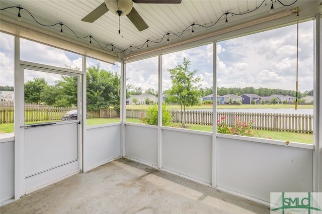 unfurnished sunroom featuring a wealth of natural light and ceiling fan