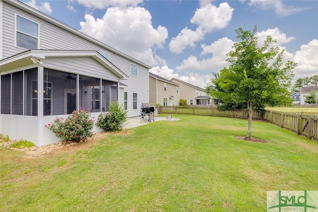 view of yard featuring a sunroom and a patio area