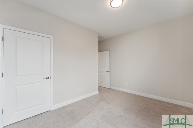 unfurnished bedroom with light colored carpet