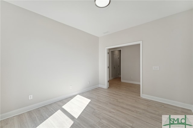 unfurnished room with light wood-type flooring